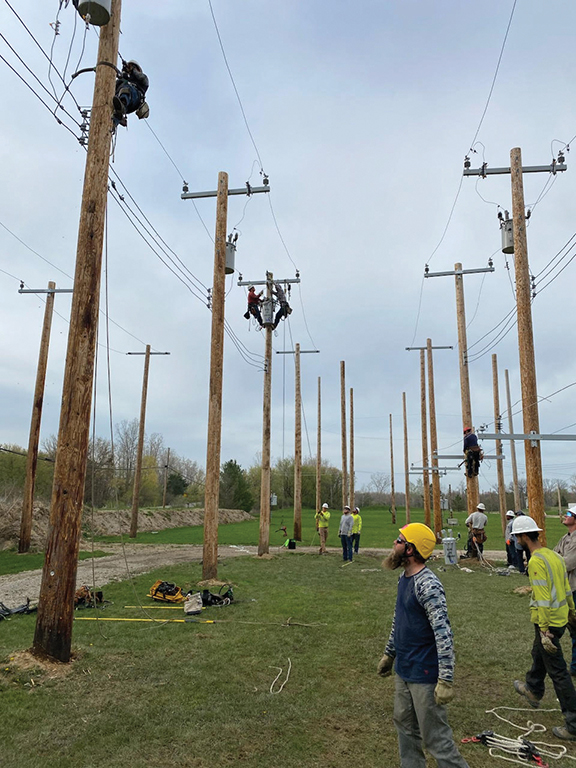 aerial photo of people working on pole