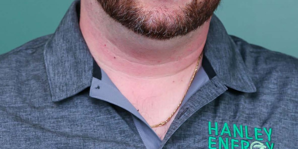 A man, Adam Geller, wears a Hanley Energy Electrical polo. Image by Adam Geller.
