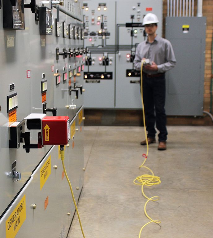 A worker remotely operates electrical equipment. Image by CBS ArcSafe, a Group CBS company.
