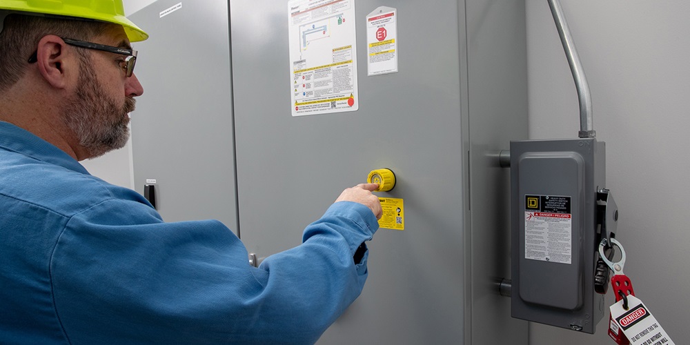 A worker examines the absence of a voltage tester. Image by Panduit Corp.