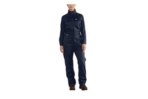 A woman wears dark blue coveralls. Image by Carhartt.