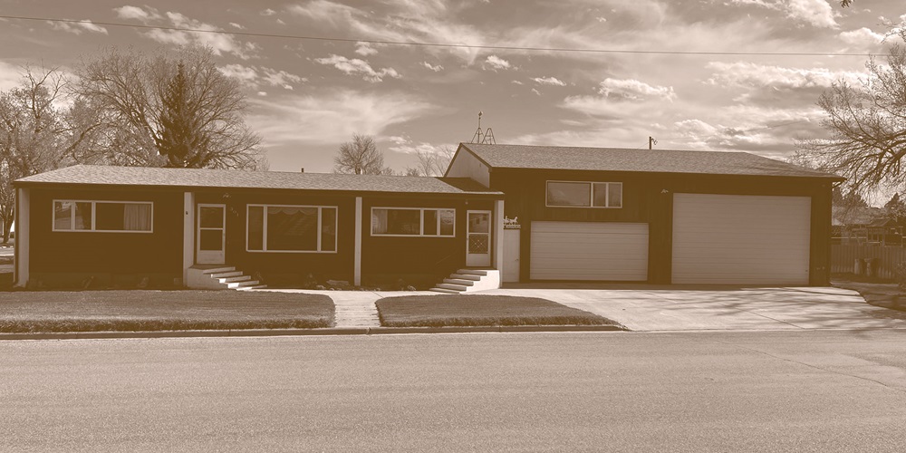 Sepia-toned photo of a split-level house and garage. Image by Mark C. Ode.