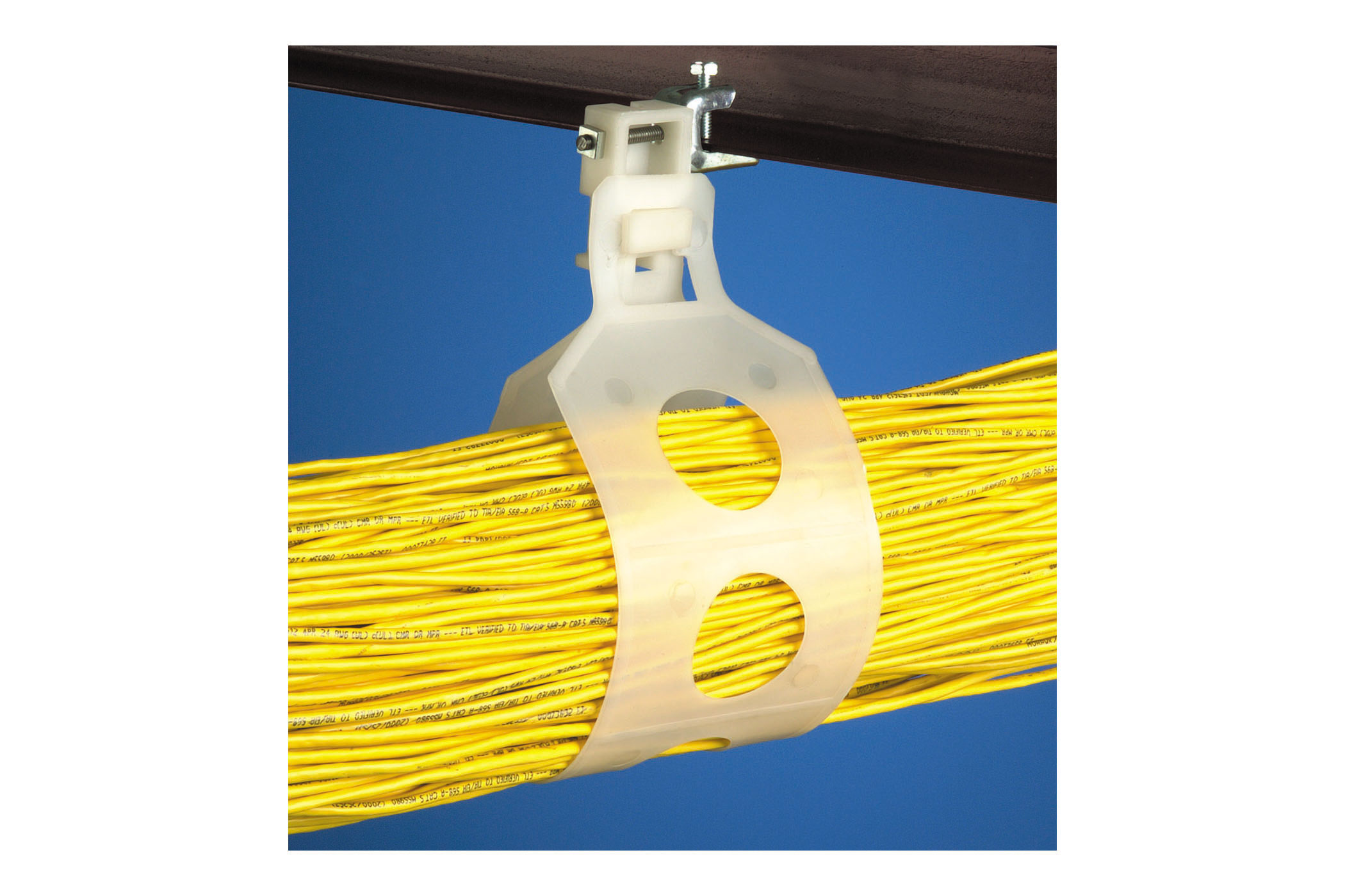 Clear cable hanger holding up yellow cables against a blue background. Image by Arlington Industries.