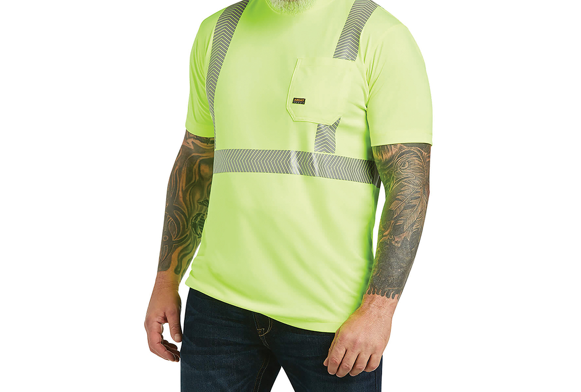 A person wears a neon t-shirt. Image by Ariat International.