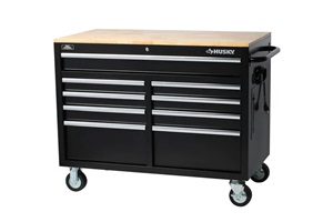 Black, nine-drawer workbench tool chest with wheels and oak top. Image by Husky.