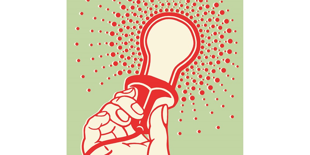 Stylized image of a hand holding a lit light bulb | iStock / CSA-Archive
