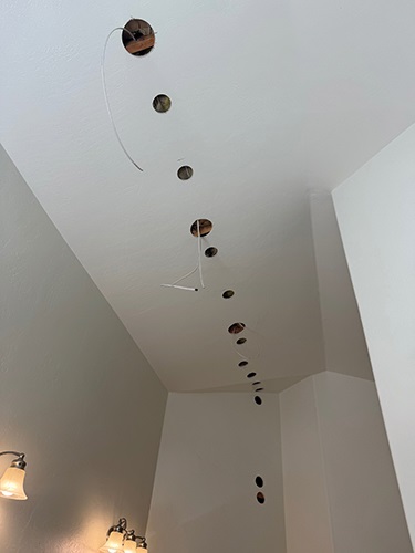 One electrician's solution to adding lighting to an area with a flat ceiling and no attic access.