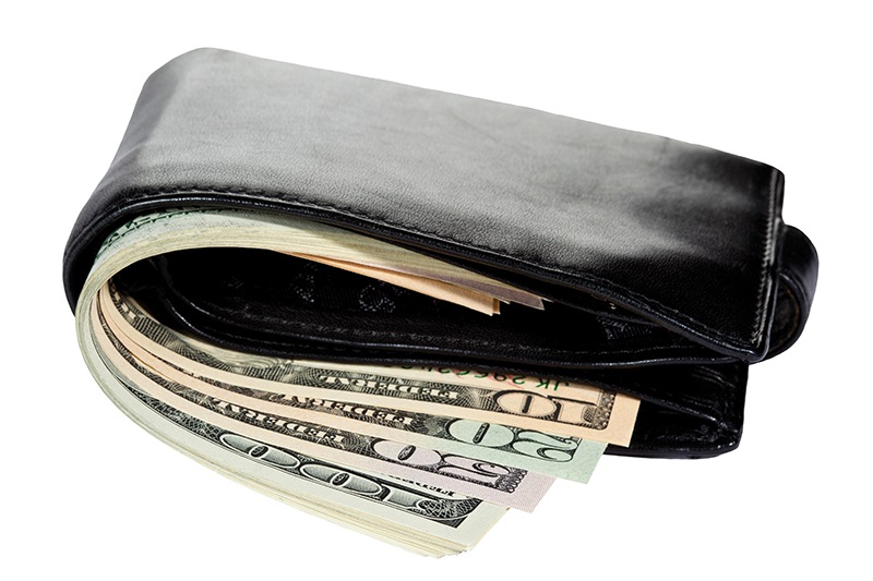 A wallet full of cash, illustrating the rebate and refund requirements that maybe involved in cost-plus contracts