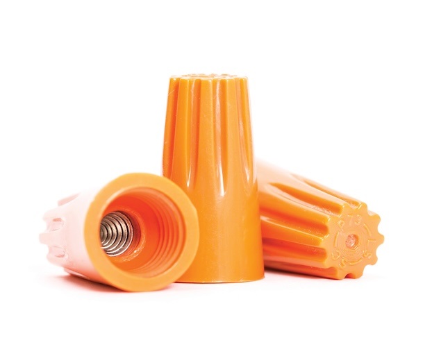 Wire nuts like the ones pictured are commonly used to connect wires today, but other older methods such as solder and tape may be found in older homes.