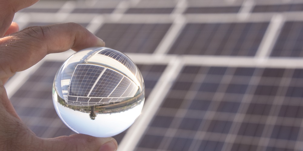 A transparent circular ball reflecting solar panels.