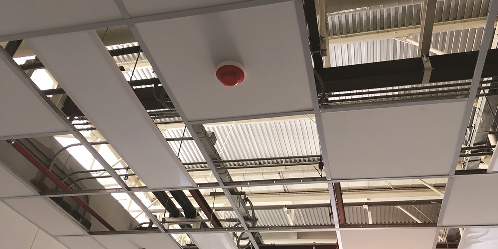 A ceiling fire alarm in commercial space.