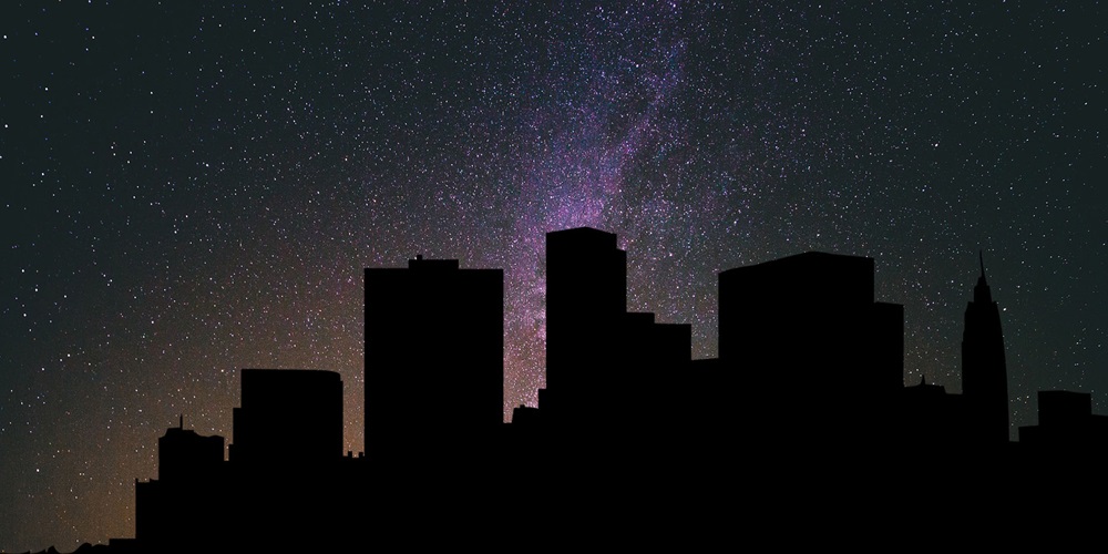 New York City skyline during a blackout, backed by a starry sky. Image by Devanath / Pixabay