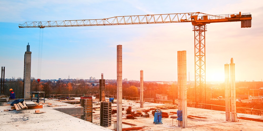 Building site under construction, with a large crane in the background