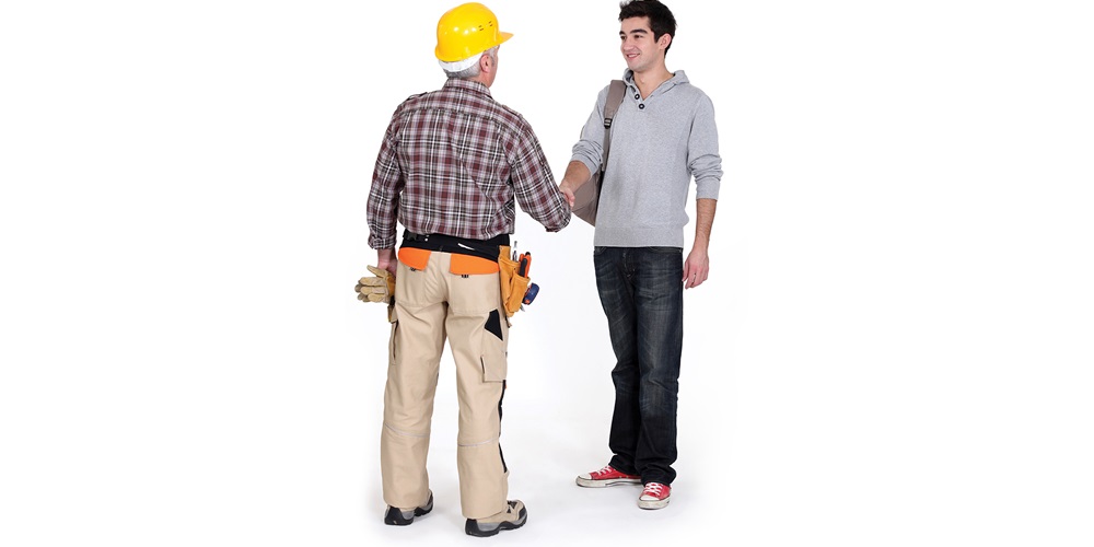 An electrician shaking hands with a young student, illustrating welcoming the younger generations into the electrical workforce