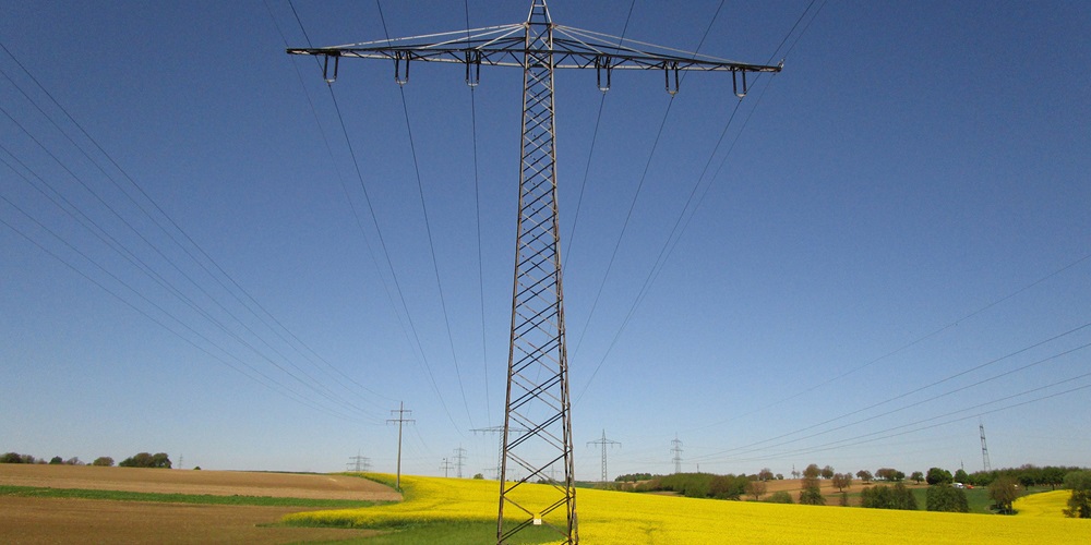 Utility tower in a rural field.