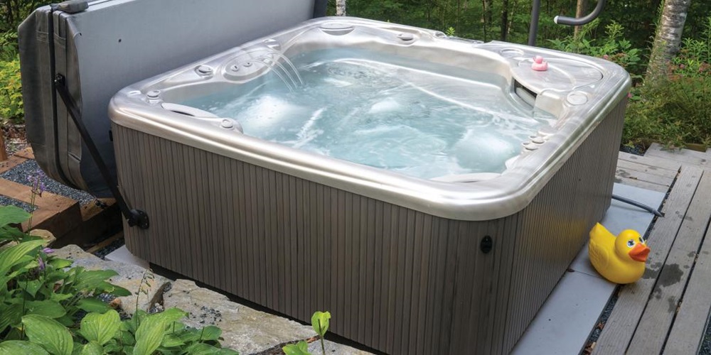Hot tub surrounded by trees and next to a large rubber duck. Image by Adobe Stock.