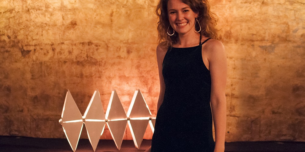 Jennifer Place stands with her winning luminaire design.