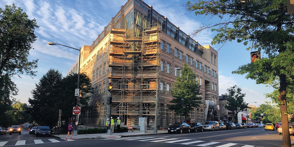 The American Geophysical Union building on a street corner, with some scaffolding. Image by the Carroll Community Center.