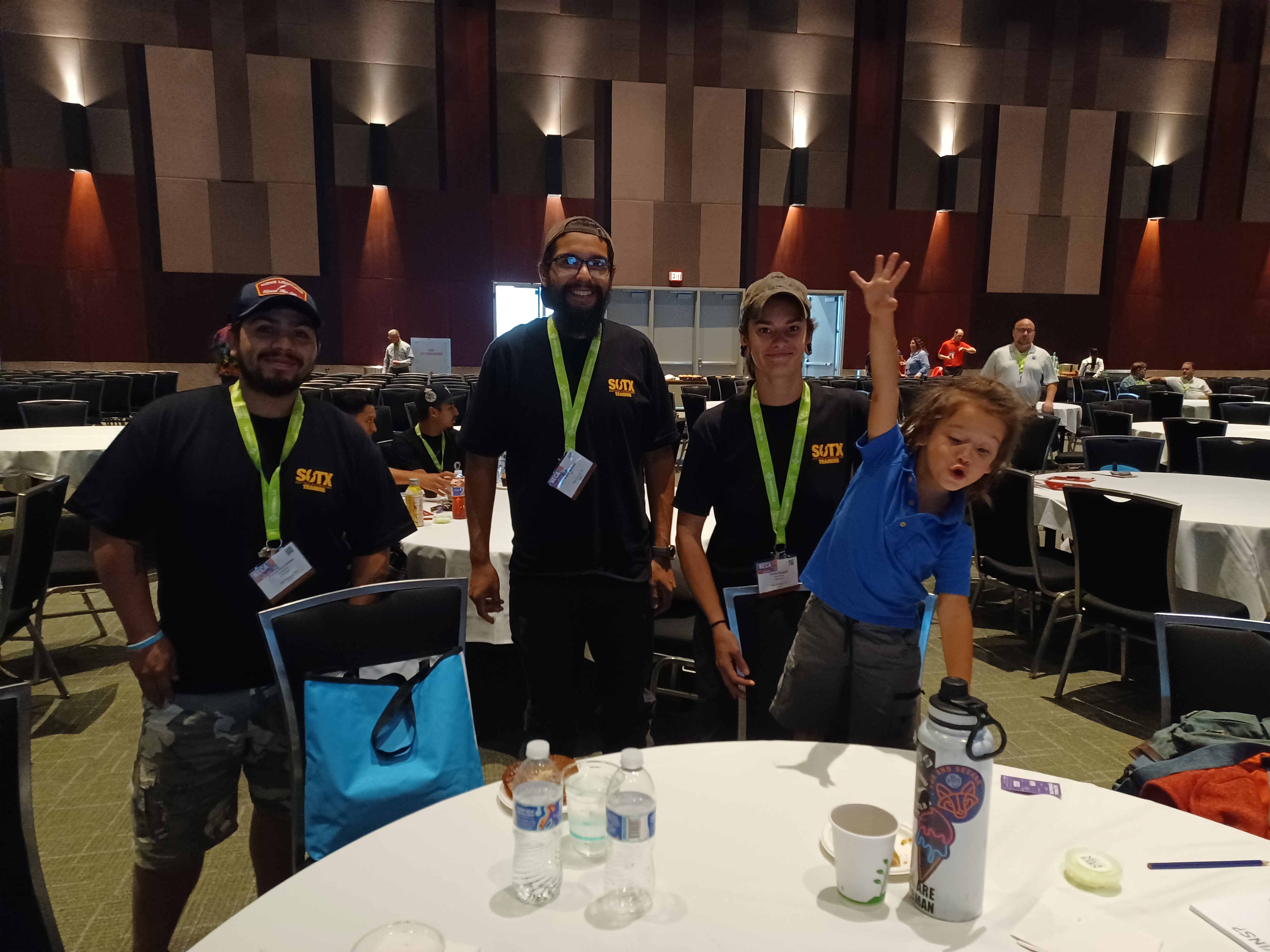 Three apprentices from Alterman Electric, (from left) Carlos Fernandez, Adam Montes and Hailey Braden - and Hailey's son, a very enthusiastic future electrician - are currently training with the South Texas JATC in San Antonio. | Photo by Colleen Beaty