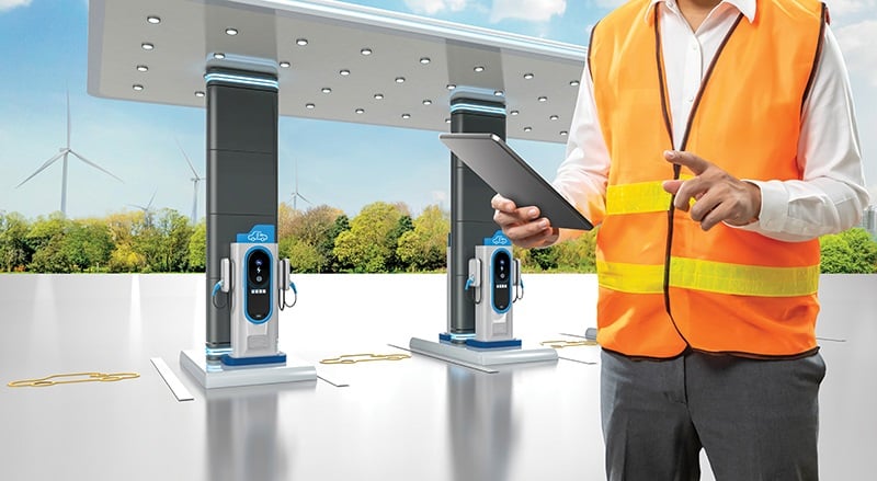 person in front of ev chargers