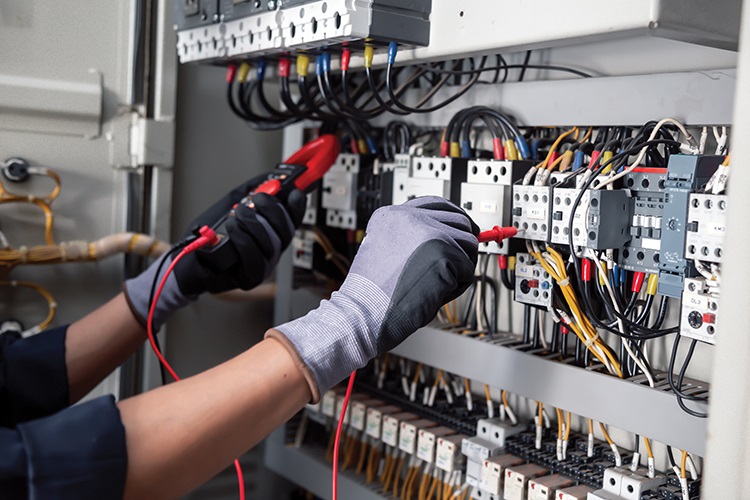 hands working on switchgear