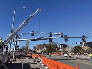 crane holding up a streetlight