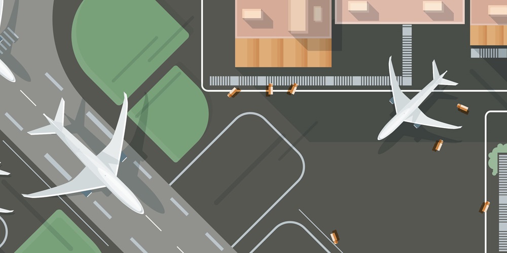 Illustration of an airport with several planes, a runway, green spaces and buildings. Shutterstock / GoodStudio