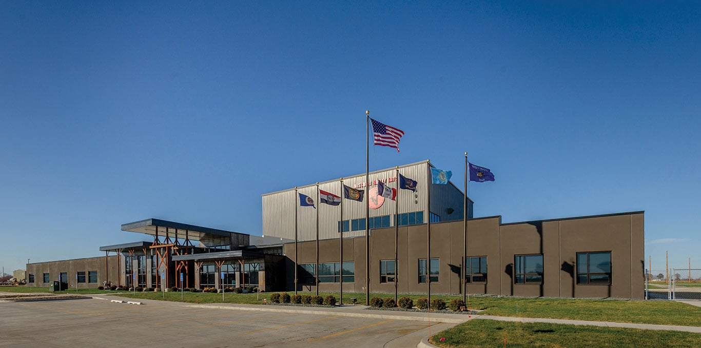 Large brown building with flags and grass. Image by Missouri Valley JATC.