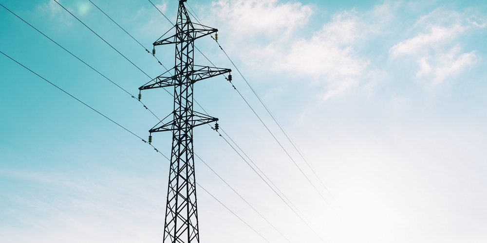Electrical utility cables amongst a clear skyline.