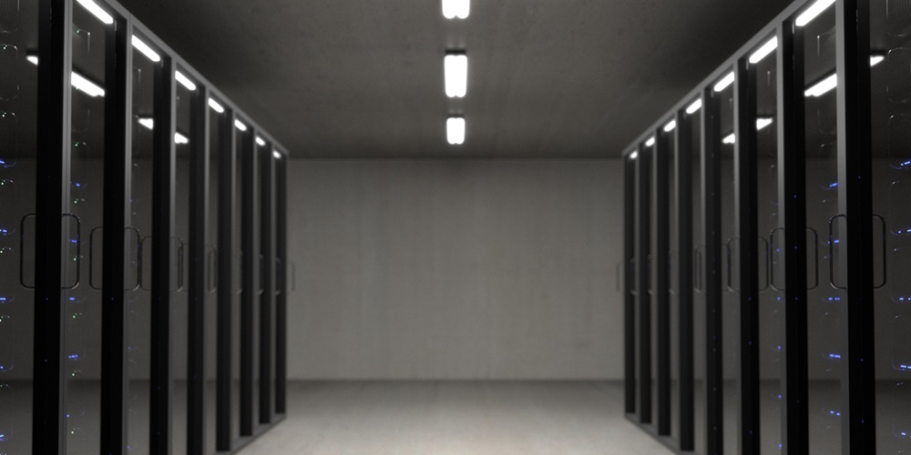 Rows of servers behind glass doors in a data center