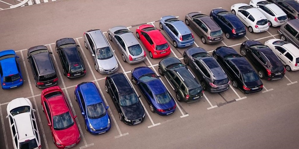 Parking lot full of cars. Image by Pixabay.