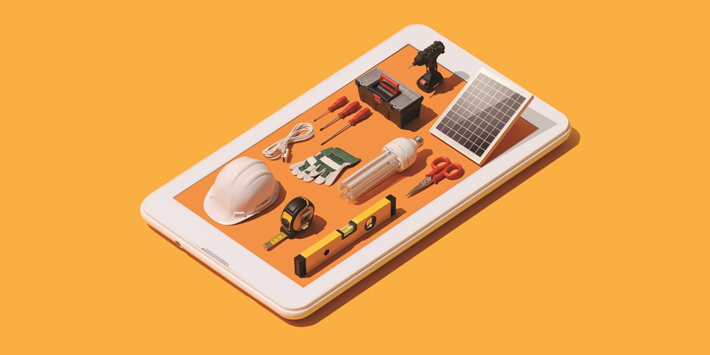 3-D construction tools and equipment laying on top of a tablet.