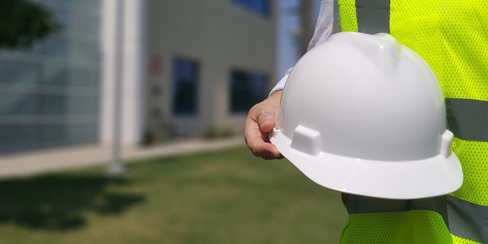 White construction hard hat worn for safety on construction sites.