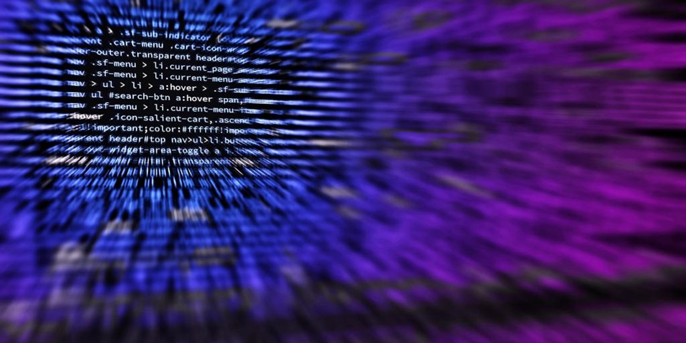Blue and purple lines of code against a black background. Image by Shutterstock.