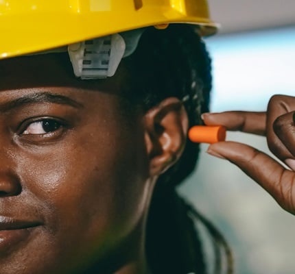 construction worker putting in ear plugs_Photo by kindel media