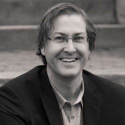 A black-and-white photo of a man, Craig DiLouie, smiling. Image by Craig DiLouie.