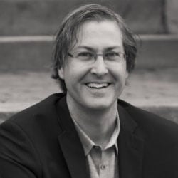 A black-and-white photo of a man, Craig DiLouie, smiling. Image by Craig DiLouie.