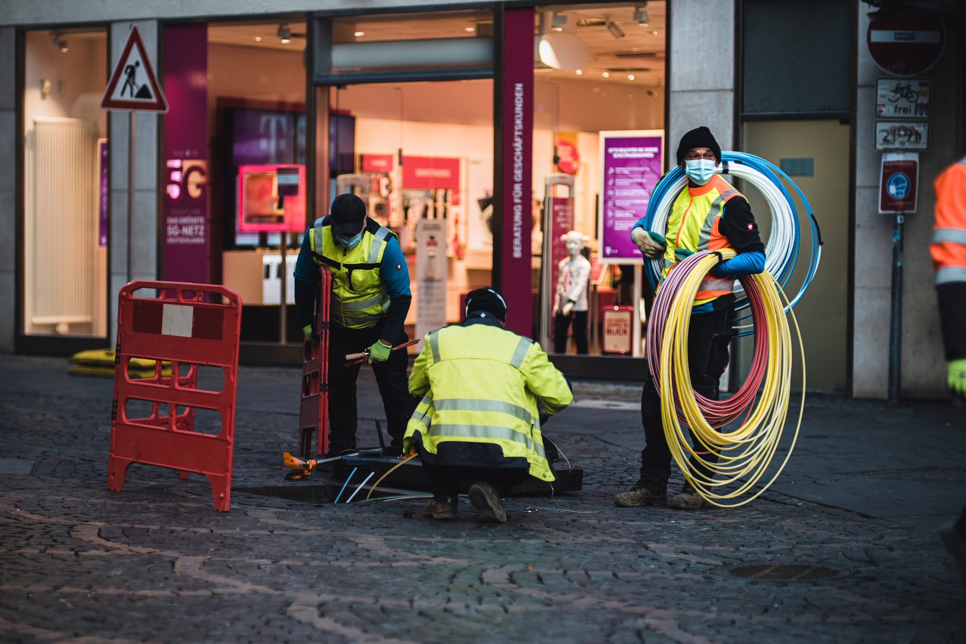 Technicians installing fiber optic cable. | Photo by Mika Baumeister on Unsplash