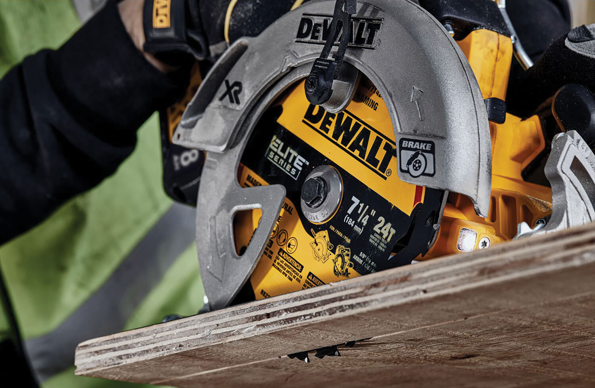 Worker using silver and yellow DeWalt branded circular saw blade on wood. Image by www.dewalt.com.