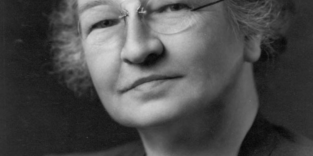 A grayscale photo of a woman, Edith Clarke, smiling. Image by Edison Tech Center.