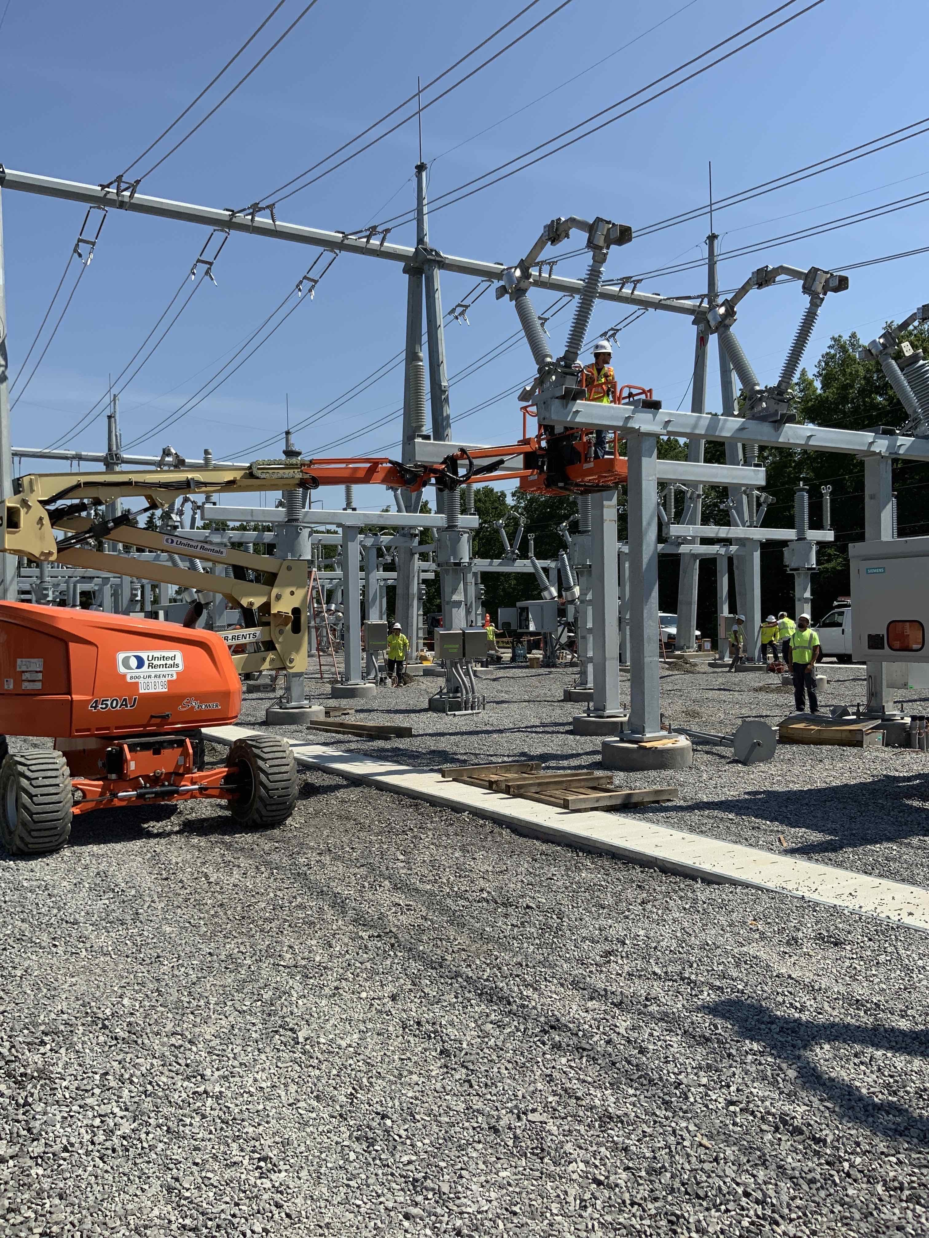 A journeyman lineworker adjusts a 115-kV disconnect switch at the Big Tree Substation expansion