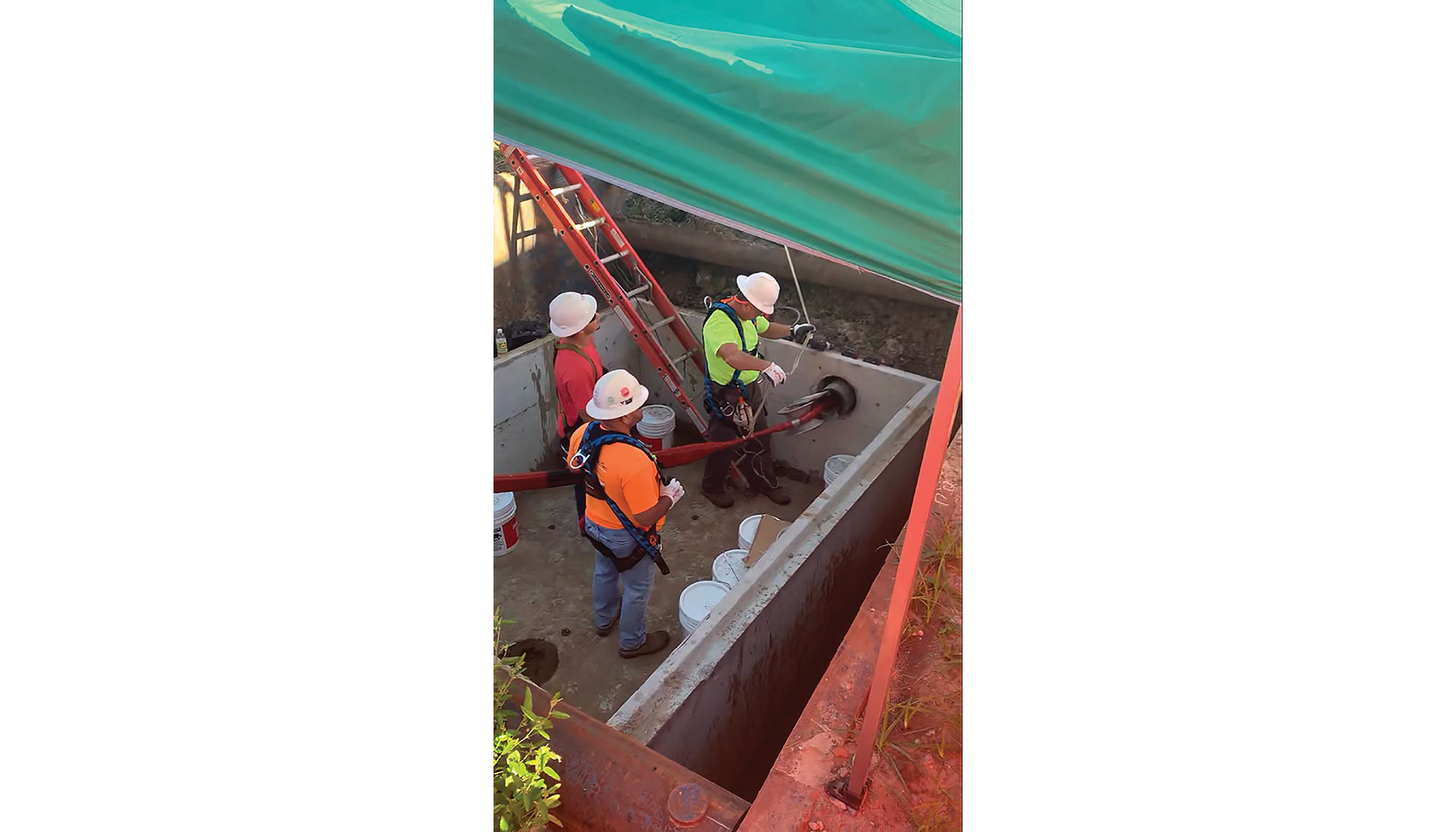 Workers in a concrete foundation under a tarp. Image by Buffalo Electric Inc.