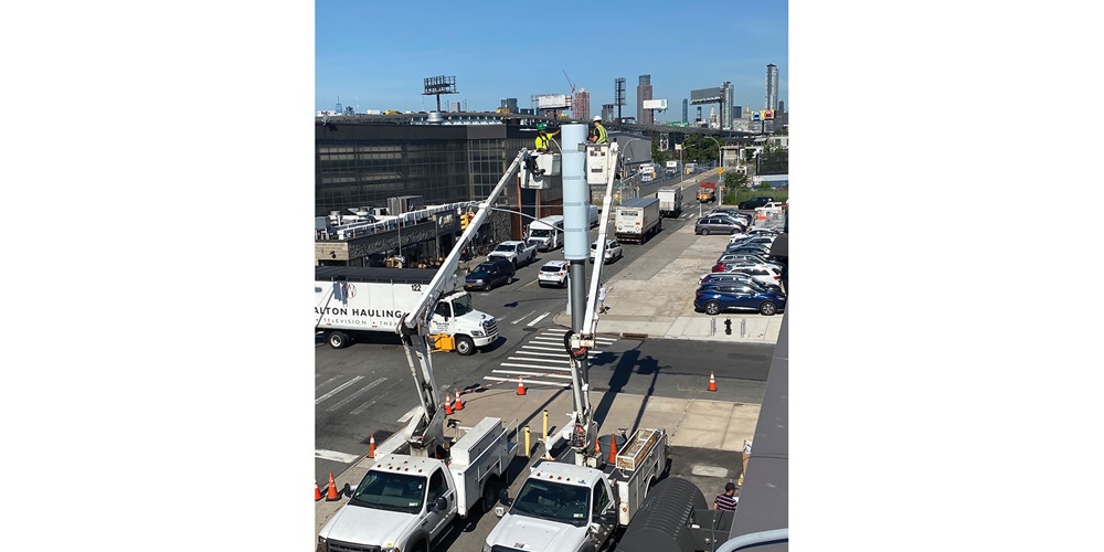 Hugh O'Kane Electric employees at work on a LinkNYC kiosk. Image by Hugh O'Kane Electric Co. Inc.