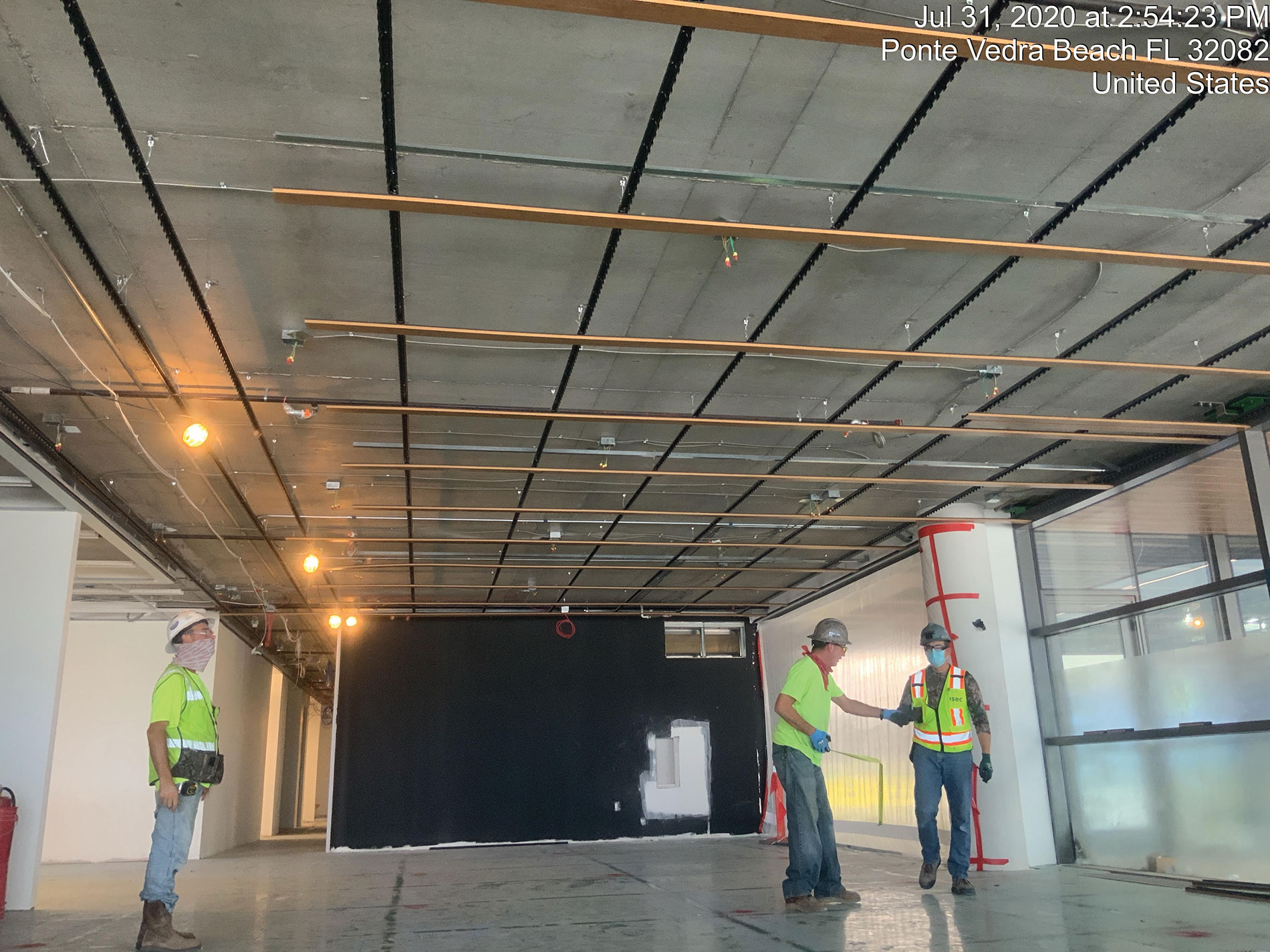 Workers under a gridded ceiling. Image by Miller Electric.