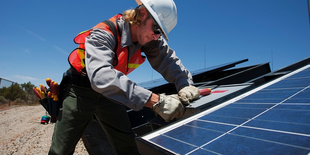 A male worker installing solar panels
