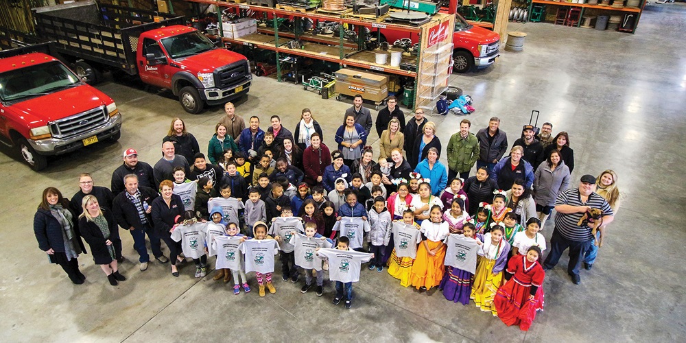 In Portland, Ore., team members from Christenson Electric pose with students from Wilkes Elementary School, a local institution they have supported with food, toys and daily-use items. Photo Credit: Christenson Electric