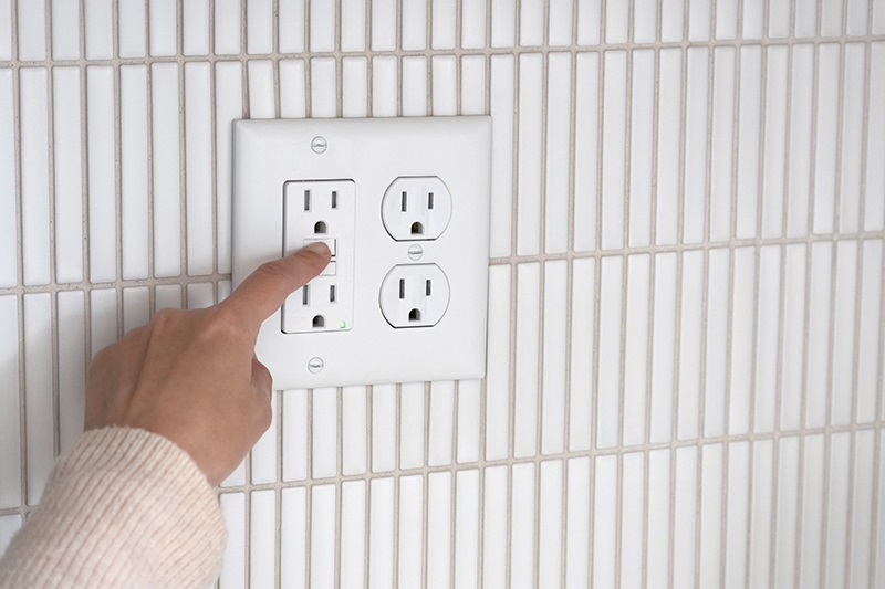 person pointing to a receptacle