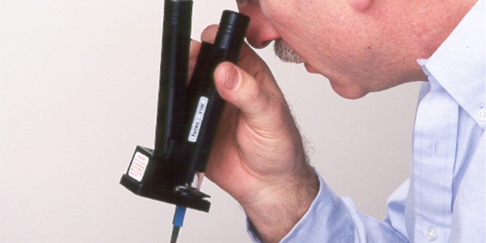 Modified Panasonic Fiber Optic Microscope, FOTEC V100 circa 1985, being used to inspect a fiber optic connection