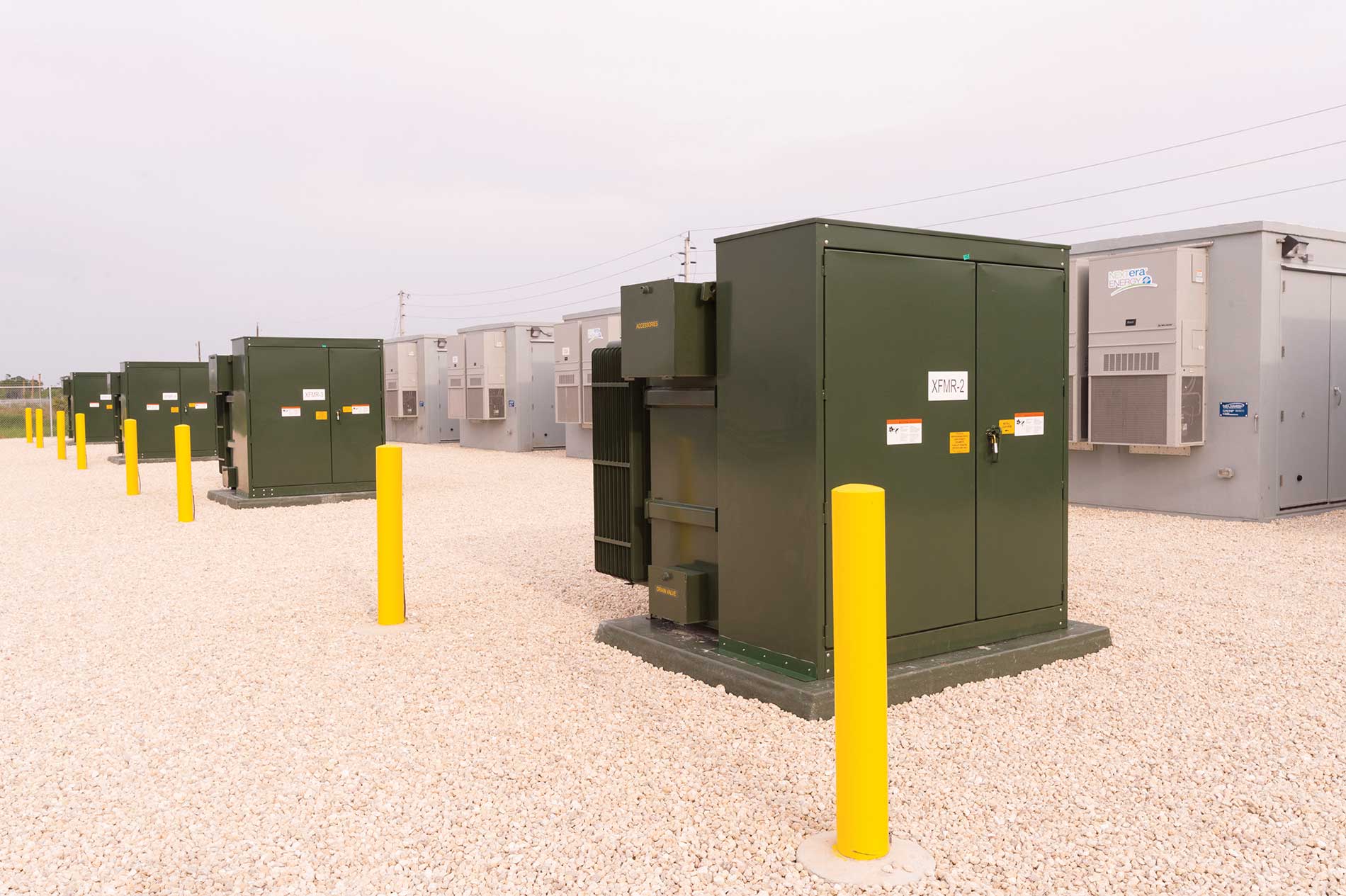 Several solar battery units in a gravel lot. Image by Florida Power & Light Co. and Babcock Ranch.