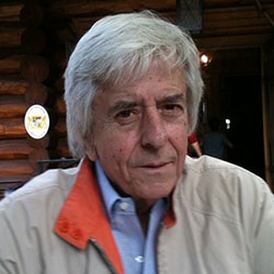 A man, Gerard Ittig, in front of a wooden background. Image by Gerard Ittig.